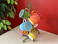 Front view of stand with all six coloured mugs displayed