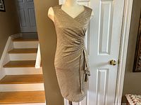 Front view on mannequin showing V-neck, draped front, side ruching