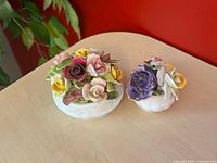 Both Coalport floral arrangements side by side