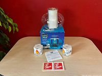 Full lot showing glass vessel atop blue Corning box, instruction sheet, two Libbey candle float boxes and decals