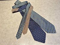Both neckties laid flat showing full length patterns