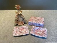 Group showing two ashtrays, lidded trinket box, shell lady figurine