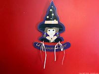 Front view showing witch design, phrase, ribbons