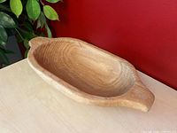 Top angled view of the wooden dough bowl showing oval shape and grain
