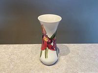 Front view of Moorcroft vase showing orchid design and overall form