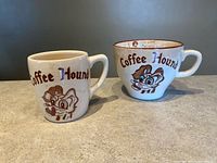 Front view of both Coffee Hound mugs showing exterior graphics