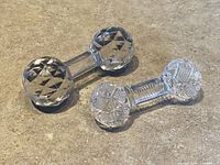 Both cut glass rests on surface showing designs