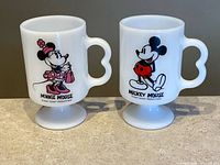 Front view of both mugs showing character graphics