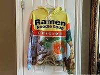Front view of ramen noodle soup hoodie hanging
