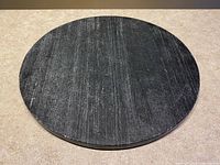 Top view of the round polished dark grey stone platter showing veining