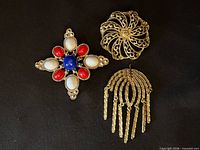 Front view of three brooches