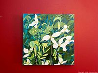 Front view of square floral painting against red wall