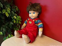 Full view of My Buddy doll seated showing clothing and overall condition