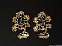 Front view of both Amway tree brooches showing cabochons and gold-tone design