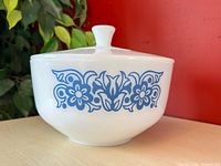 Bowl with lid showing blue Daisy & Tulip pattern front view