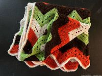 Folded crochet ripple afghan showing colors and texture