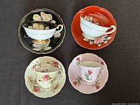 Top view of four matching teacup and saucer sets displaying colors and motifs