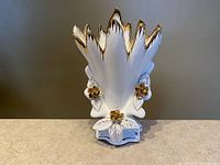 Front view showing fan shape, floral appliqués, and gold trim