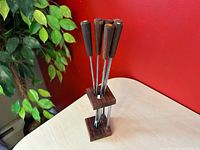 Complete set of six fondue forks in wooden stand