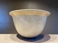 side view of stoneware bowl showing overall shape and glaze