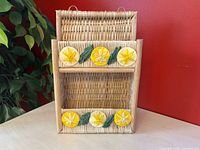 Front view of wicker shelf showing lemon motif and two tiers
