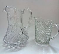 Front view of both pitchers displaying overall shapes and patterns