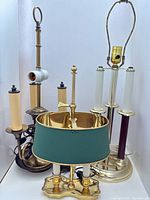All three brass lamps grouped together showing relative sizes and features