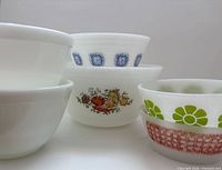 Group of six milk glass bowls showing patterns and sizes