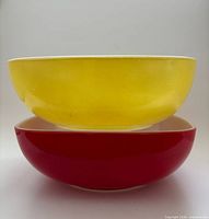 Yellow bowl stacked on red bowl, side view shows exterior colors and shape