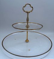 Full view of two-tier glass stand showing both plates and handle