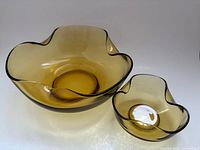 Large and small amber bowls side by side