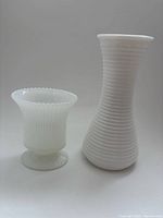 Both milk glass vases side by side to show forms and scale