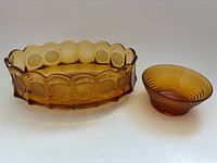 Both amber glass pieces side by side for size comparison