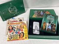 Open presentation case displaying booklet, campaign book, ephemera, metal tin, DVD case