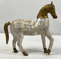 Full side view of brass and mother-of-pearl horse figurine