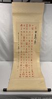 Full view of the hanging scroll unrolled showing entire design and roller