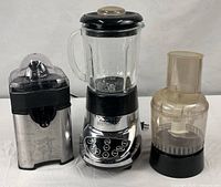 Juicer and blender/processor pictured side by side