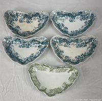 Five crescent scrap dishes arranged for overview