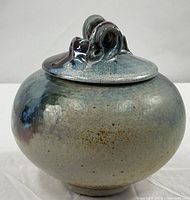 Front view of glazed stoneware lidded jar