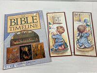 Front view of book and two wall plaques, all shrink wrapped