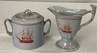 Cream pitcher and lidded sugar bowl set front view