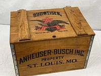Overall view of wood storage box showing Budweiser logo and metal side straps