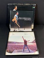 Front of box with booklet and an inner sleeve displayed