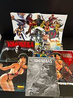 All six items displayed: three Vampirella print pieces and three posters/inserts