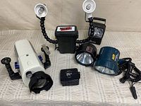 Group view showing Amphibico housing, Pro Watt light rig, black spotlight, teal spotlight and small accessories