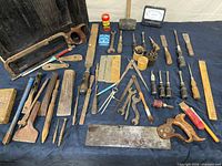 Overhead view of full assortment of antique tools laid out
