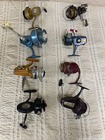 All eight reels laid out in two columns on fabric surface