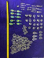 Group layout with measuring tape showing various crystal shapes and sizes