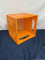 Front/side view of orange plastic milk crate
