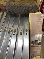 Overview of steel studs, chicken wire roll, laminate flooring box
